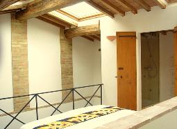 The bedroom has a wood beamed ceiling
